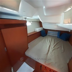Interior cabin of 2008 Beneteau Oceanis 43 sailboat with cozy bed and pillows.