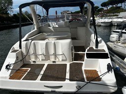 2011 Mano Marine 28.50 Sport boat docked, featuring spacious seating and sleek design.