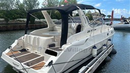 2011 Mano Marine 28.50 Sport boat docked, featuring sleek design and spacious deck.