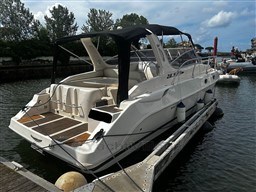 2011 Mano Marine 28.50 Sport boat docked, featuring sleek design and spacious deck.