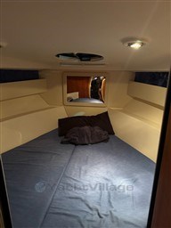 Interior cabin of 2011 Mano Marine 28.50 Sport boat, featuring cozy sleeping area.