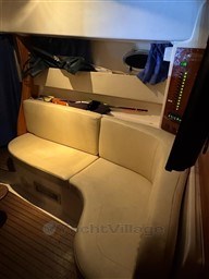 2011 Mano Marine 28.50 Sport interior with beige seating and wooden flooring.