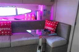 Luxurious interior of 2006 Azimut Atlantis 55 yacht with stylish seating and vibrant lighting.