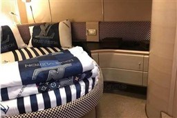 Luxurious bedroom interior of 2006 Azimut Atlantis 55 yacht with designer bedding.
