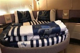Luxurious Louis Vuitton bedding in a 2006 Azimut Atlantis 55 yacht cabin.