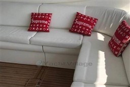 Luxurious white seating with red Supreme pillows on Azimut Atlantis 55 yacht, 2006 model.
