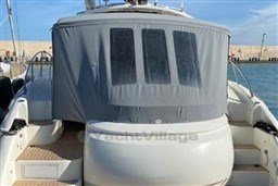 2006 Azimut Atlantis 55 yacht with covered cockpit, docked at a marina.