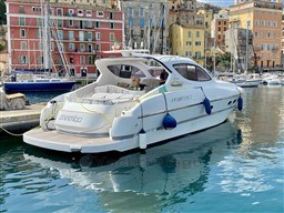2004 Primatist G 50 Speedster yacht docked in a vibrant harbor setting.