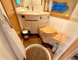 Bathroom interior of 2004 Primatist G 50 Speedster yacht, featuring wooden accents and compact design.