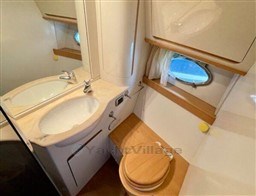 Luxurious bathroom in 2004 Primatist G 50 Speedster yacht with sink and porthole.