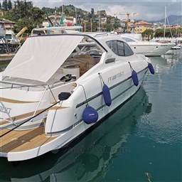 2004 Primatist G 50 Speedster yacht docked in a scenic marina.