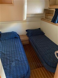 Twin cabin with blue bedding in 2004 Primatist G 50 Speedster yacht.