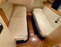Twin cabin interior of 2004 Primatist G 50 Speedster with wooden flooring.
