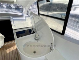 Interior of 2004 Primatist G 50 Speedster yacht with open sink and wooden flooring.