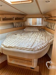 Luxurious cabin interior of 2004 Primatist G 50 Speedster yacht with cozy bed.
