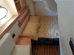 Cozy cabin interior of 2004 Primatist G 50 Speedster with bed and wooden accents.