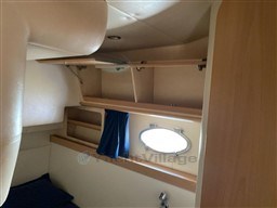 Interior cabin of 2004 Primatist G 50 Speedster with storage and porthole.