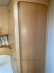 Wooden interior of 2004 Primatist G 50 Speedster yacht, featuring sleek cabinetry and curtain detail.