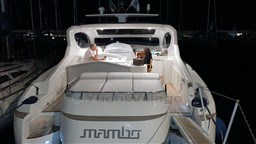 2004 Primatist G 50 Speedster yacht at night with people onboard.