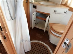 Bathroom interior of 2004 Primatist G 50 Speedster yacht, featuring wooden accents and compact design.