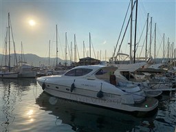 2004 Primatist G 50 Speedster yacht docked at marina during sunset.