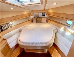 Luxurious cabin interior of 2004 Primatist G 50 Speedster yacht with cozy bed.