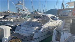 2004 Primatist G 50 Speedster yacht docked in a marina, surrounded by other boats.