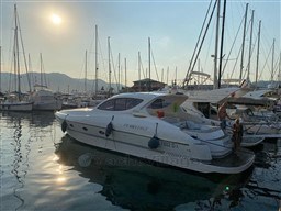 2004 Primatist G 50 Speedster yacht docked at marina during sunset.