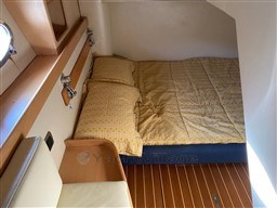 Cozy cabin interior of 2004 Primatist G 50 Speedster with wooden flooring and comfortable bedding.