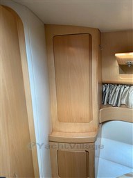 Interior of 2004 Primatist G 50 Speedster with wooden cabinetry and curtains.