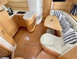 Luxurious interior of 2004 Primatist G 50 Speedster yacht with modern kitchen and seating area.