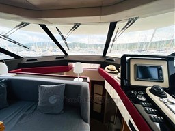 Interior view of 2011 Azimut Magellano 50 yacht, featuring modern navigation equipment and comfortable seating.