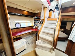 Interior of 2011 Azimut Magellano 50 yacht with stairs, seating, and cozy cabin.