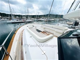 Luxurious 2011 Azimut Magellano 50 yacht with spacious deck seating in a marina.