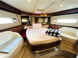 Luxurious bedroom interior of 2011 Azimut Magellano 50 yacht with elegant furnishings.