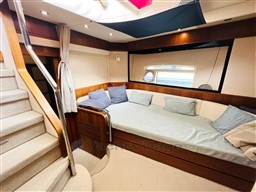 Luxurious interior of 2011 Azimut Magellano 50 yacht with cozy seating and elegant design.