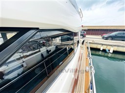 Azimut Magellano 50 yacht, 2011 model, docked with sleek design and wooden deck.