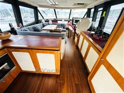 Luxurious interior of 2011 Azimut Magellano 50 yacht with elegant wood finishes and spacious seating.