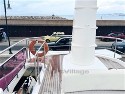 Azimut Magellano 50 yacht deck, 2011 model, docked near a coastal road.