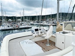 Azimut Magellano 50 yacht, 2011 model, docked in a marina with scenic background.