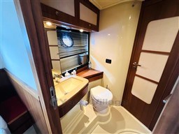 Azimut Magellano 50 yacht bathroom, featuring sink, toilet, and porthole window, 2011 model.