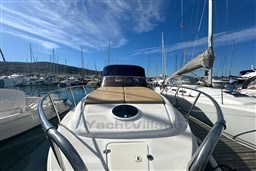 2007 Mano Marine 24.50 boat docked in a marina under a clear blue sky.