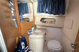 Bathroom interior of 2007 Mano Marine 24.50 boat with sink, toilet, and mirror.