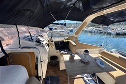 Interior of 2007 Mano Marine 24.50 boat with helm and seating area.