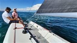 2024 Comuzzi Yachts C-32 Sport sailing on open water with two people onboard.