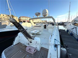 2006 Cranchi Smeraldo 37 yacht docked at marina, featuring spacious deck and modern equipment.