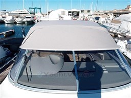 2006 Cranchi Smeraldo 37 yacht docked at a marina, featuring a covered cockpit.
