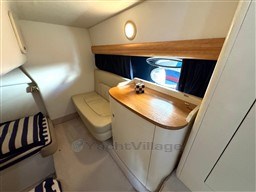 2006 Cranchi Smeraldo 37 cabin interior with seating and wooden accents.