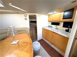 Interior of 2006 Cranchi Smeraldo 37 yacht with kitchenette and seating area.