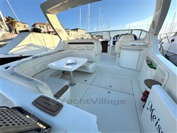 2006 Cranchi Smeraldo 37 yacht interior with white seating and table, docked at marina.